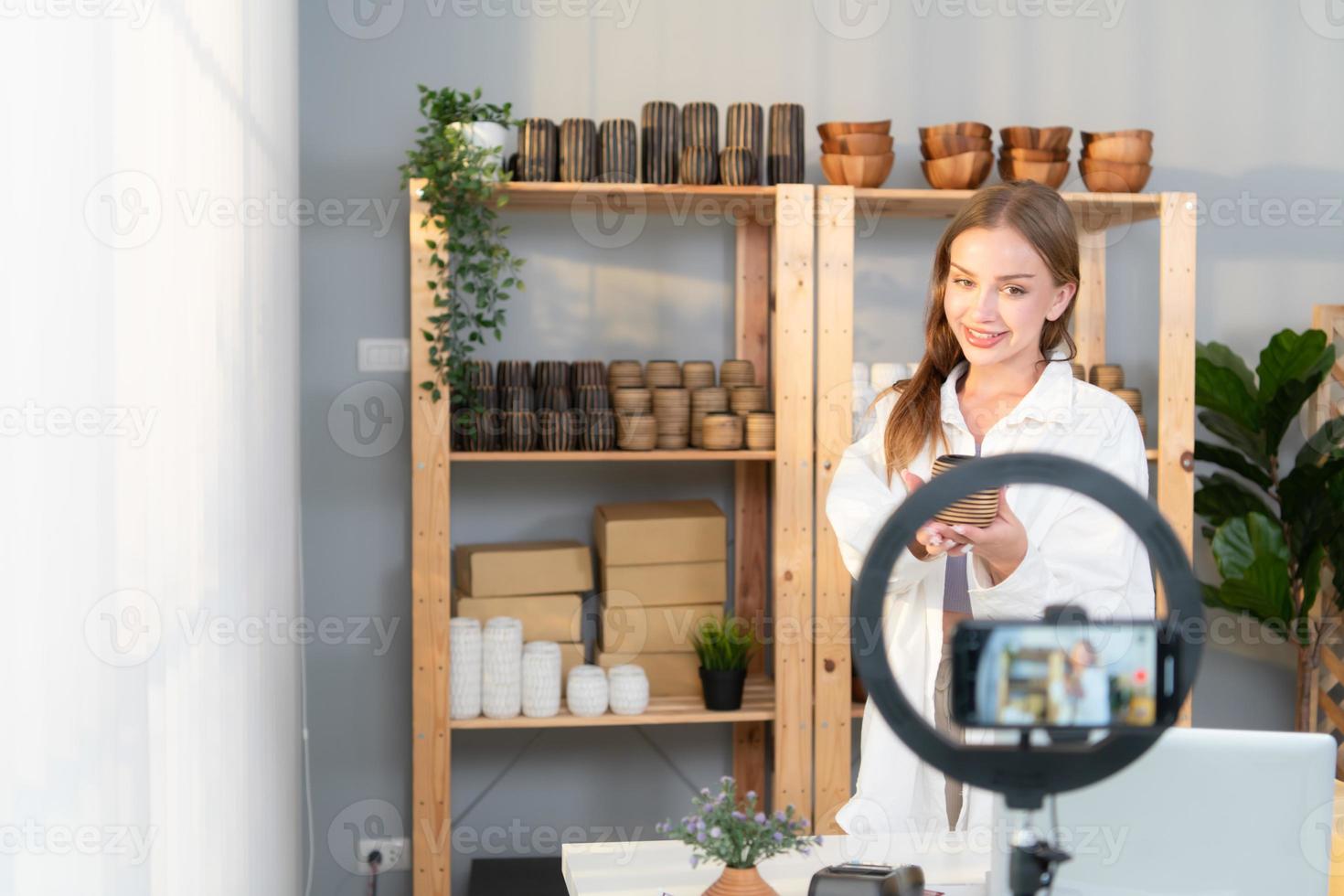 Young female runs a small business making clay jewelry. Presented to customers with products via an internet channel. photo