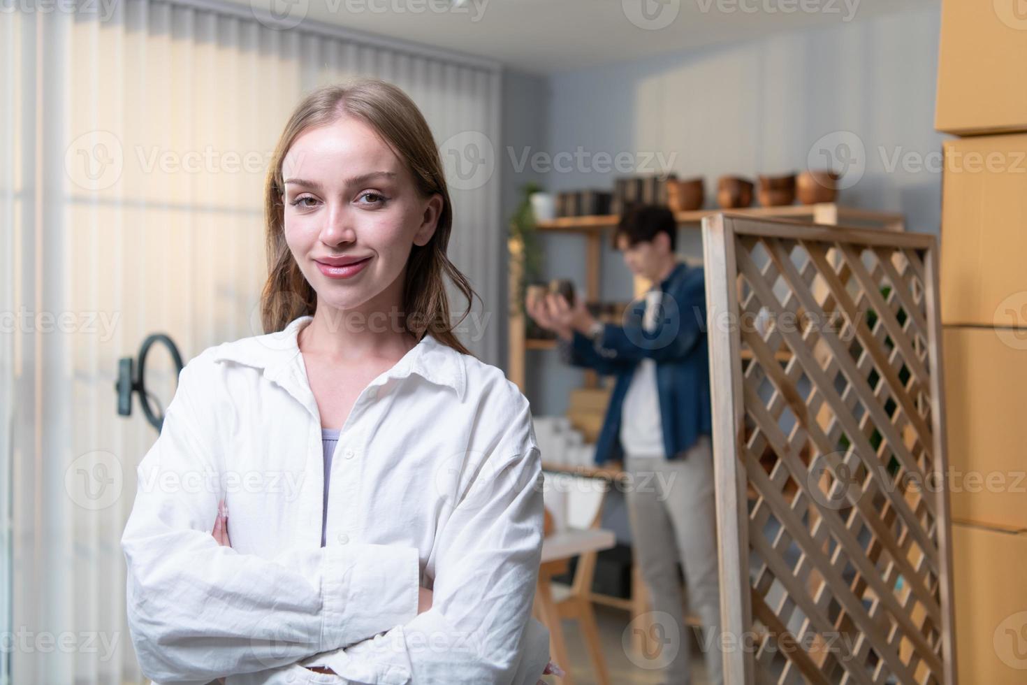 Portrait of young couple runs a small business making clay jewelry. They support one another as they work toward becoming larger business in the future. photo