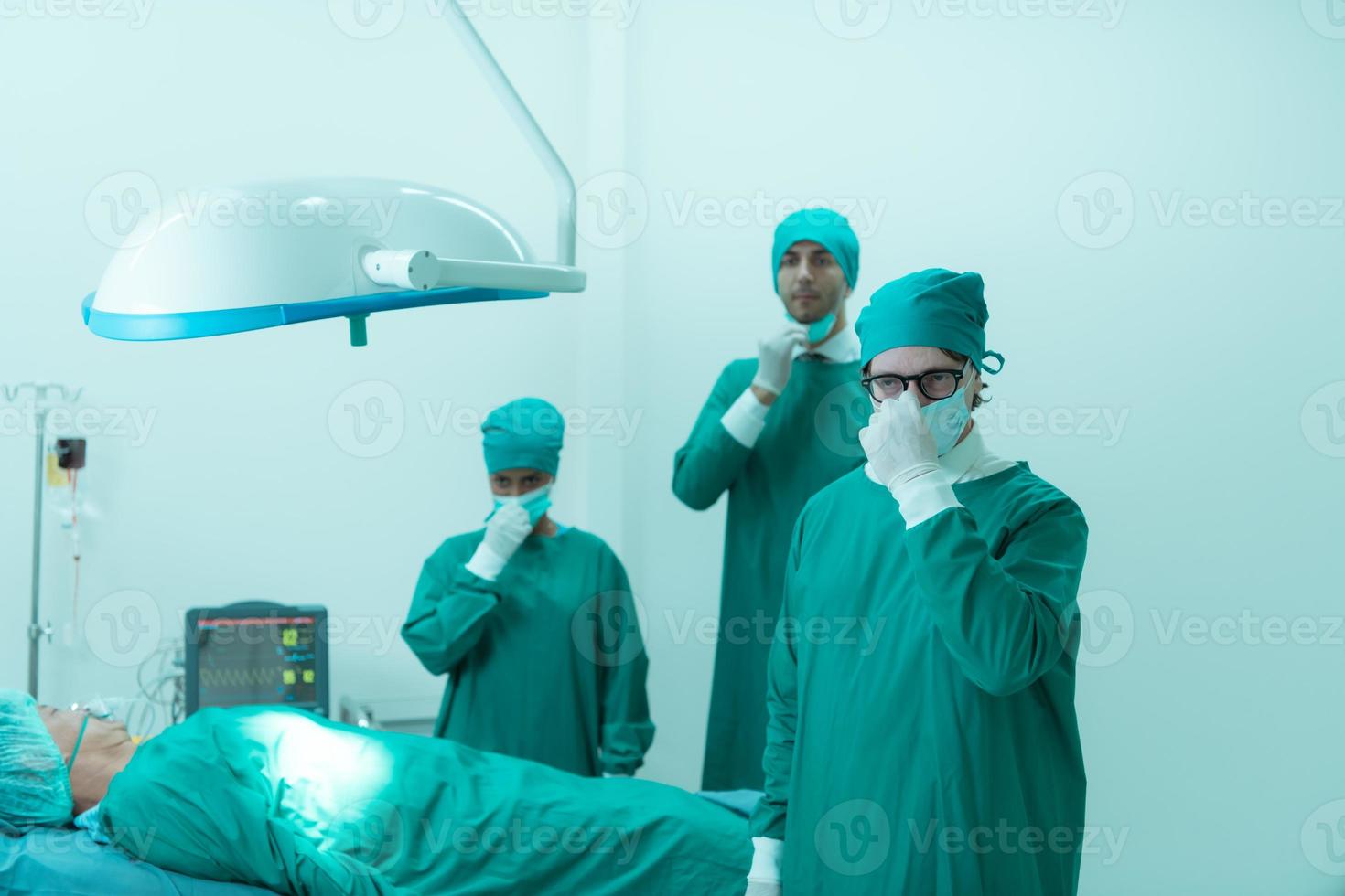 Portrait of professor of medicine in cardiology and a team of doctors in the operating room undergoing heart transplant surgery photo