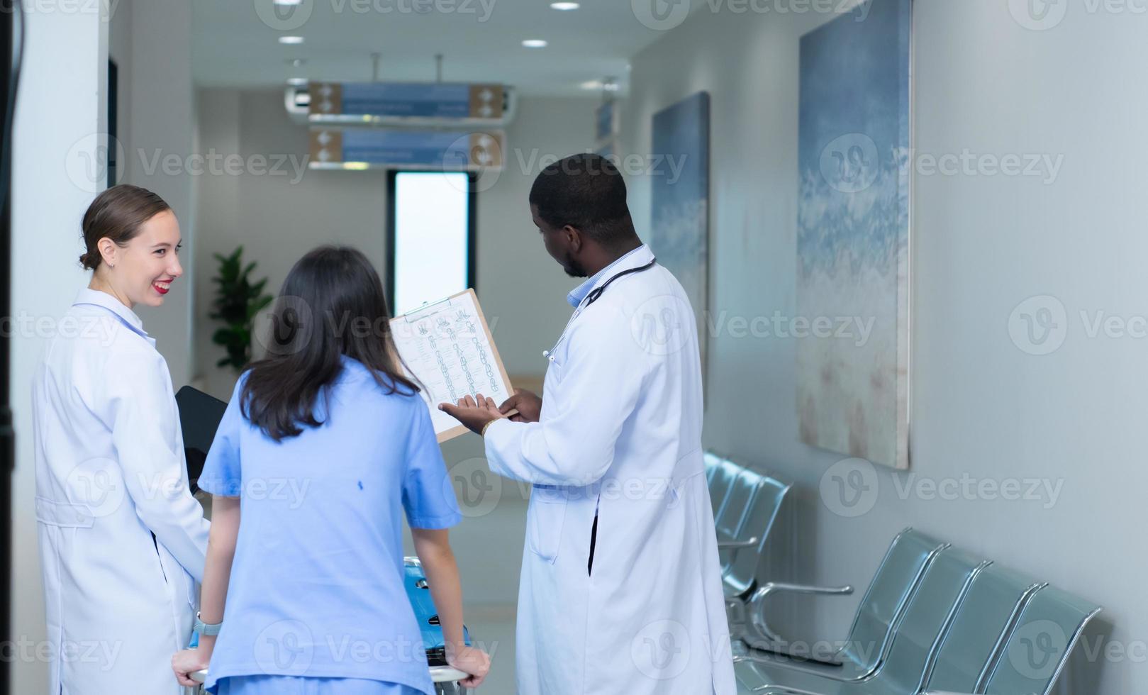 Medical professor and intern looking at an MRI of a patient who received a concussion to the head after an accident. and inform the patient that the brain is normal photo