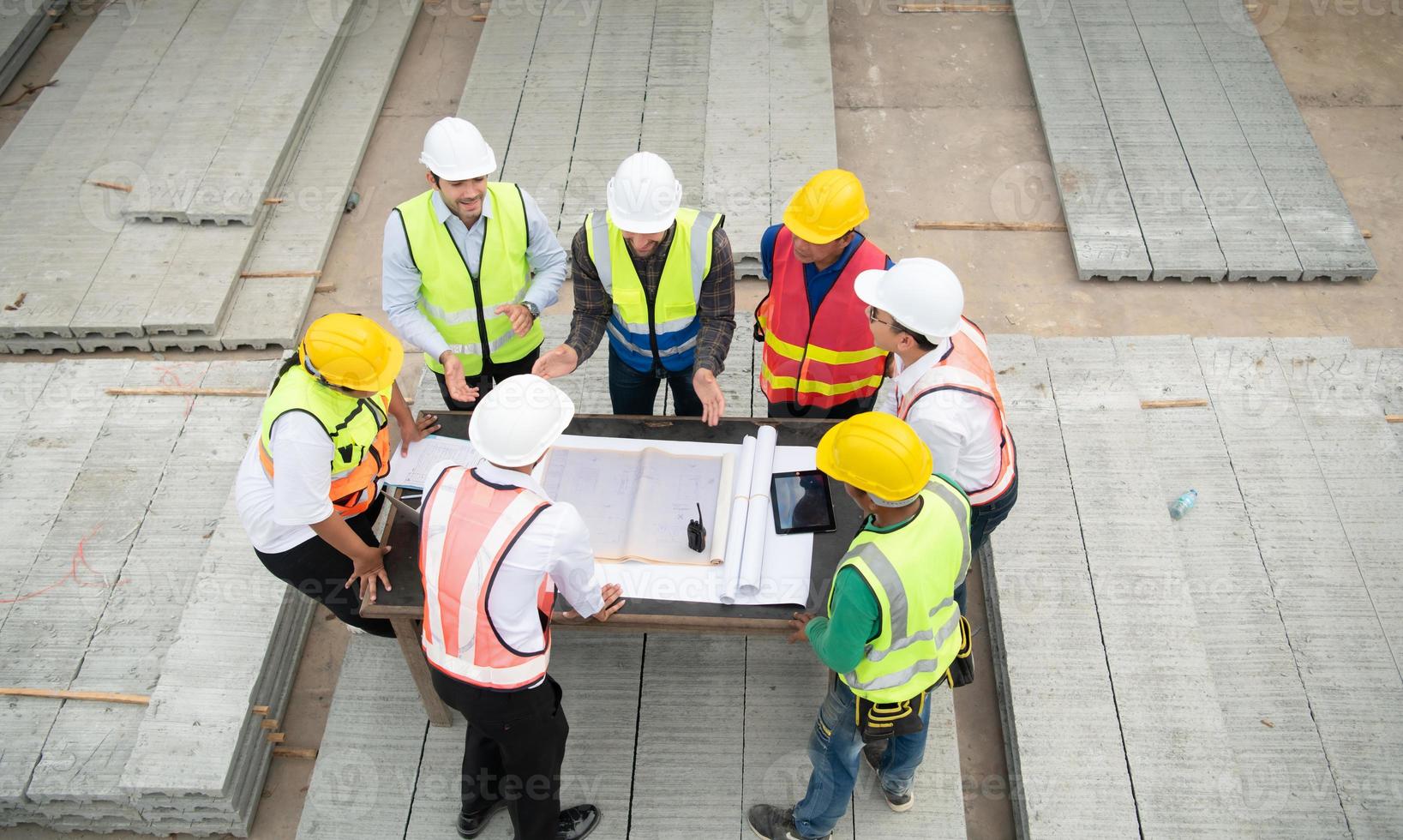 Construction engineers, architects, and foremen form a group. Participate in a meeting to plan new construction projects. photo