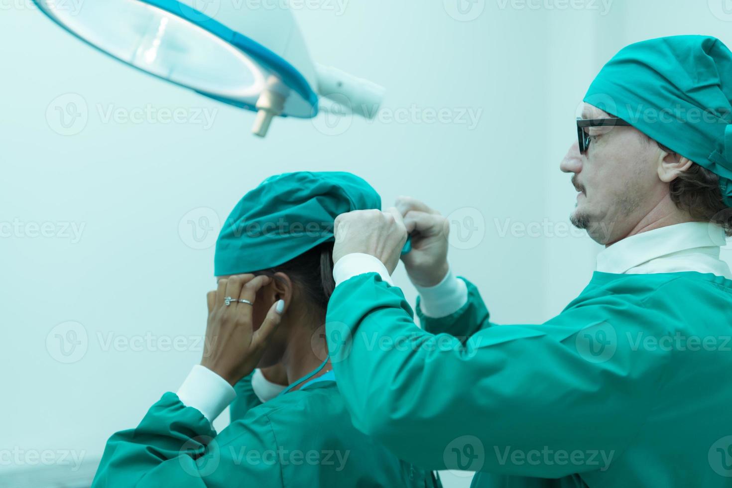 Portrait of professor of medicine in cardiology and a team of doctors in the operating room undergoing heart transplant surgery photo