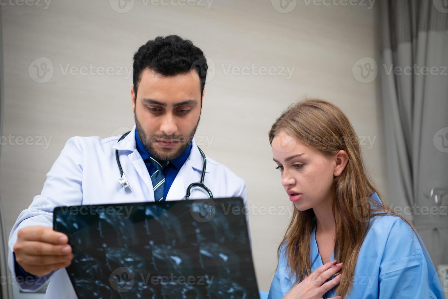 Doctor see brain x-ray results of a patient who suffered a concussion after the accident. and inform the patient that the brain is normal photo