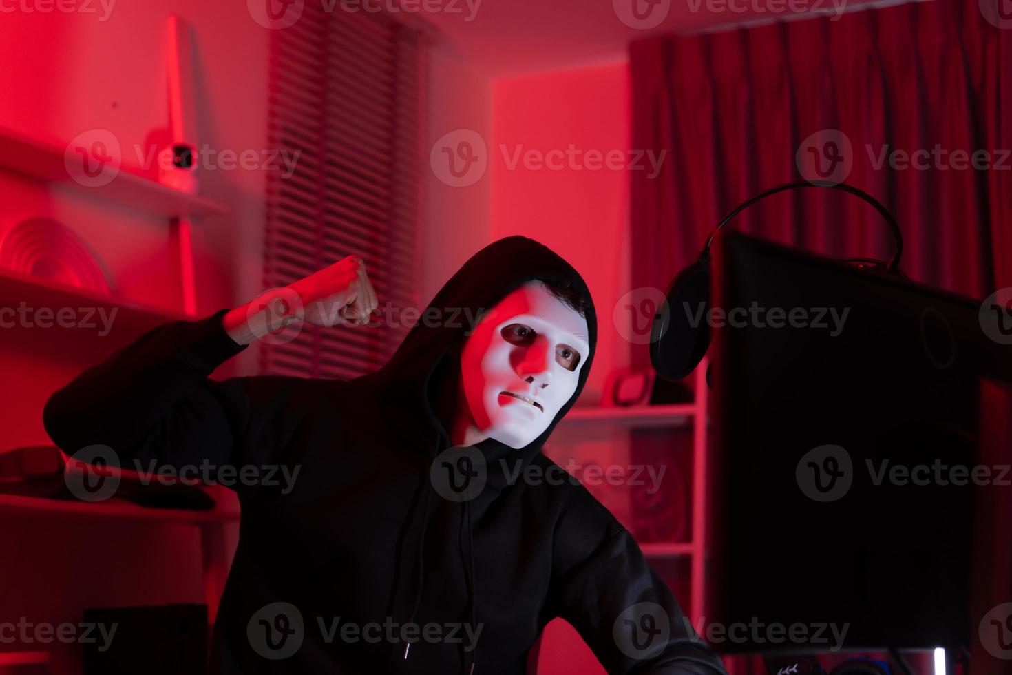 This is the face of a hacker who is knowledgeable with operating systems and other programs. He will exploit flaws and breach the computer system to cause damage. photo