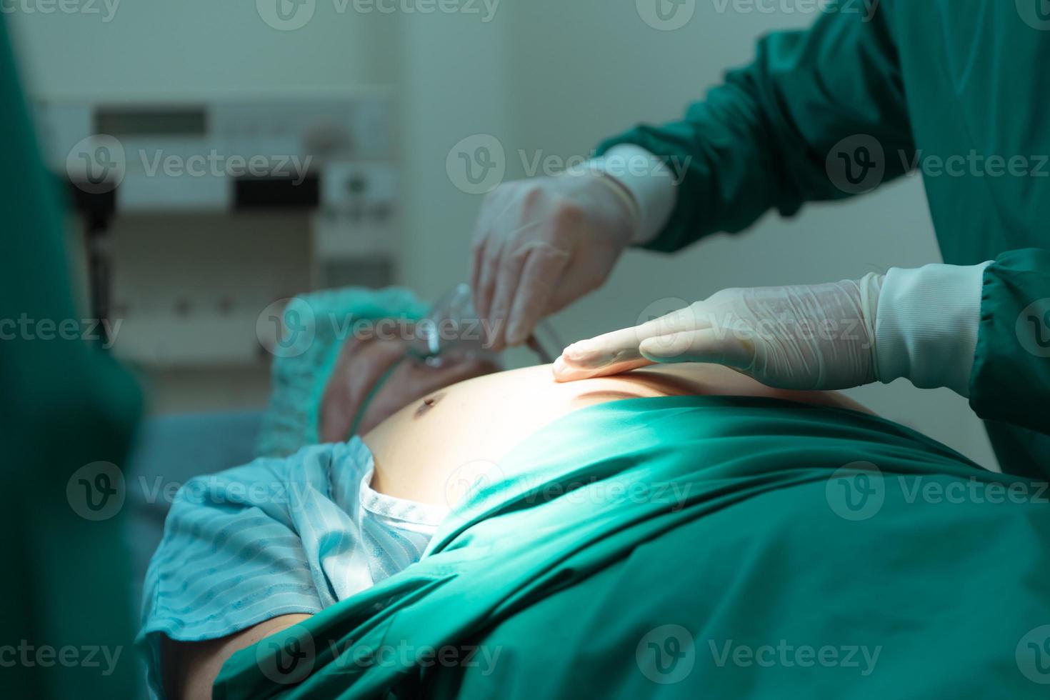 Medical lecturer in cardiology and medical team in the heart transplantation room A knife is being used for surgery on a patient. photo