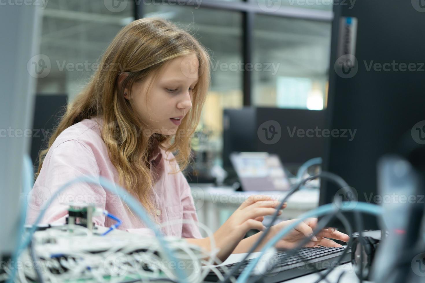 Youngsters utilizing the hand robot technology are having fun learning the electronic circuit board and hand robot controller of robot technology, which is one of the STEM courses. photo