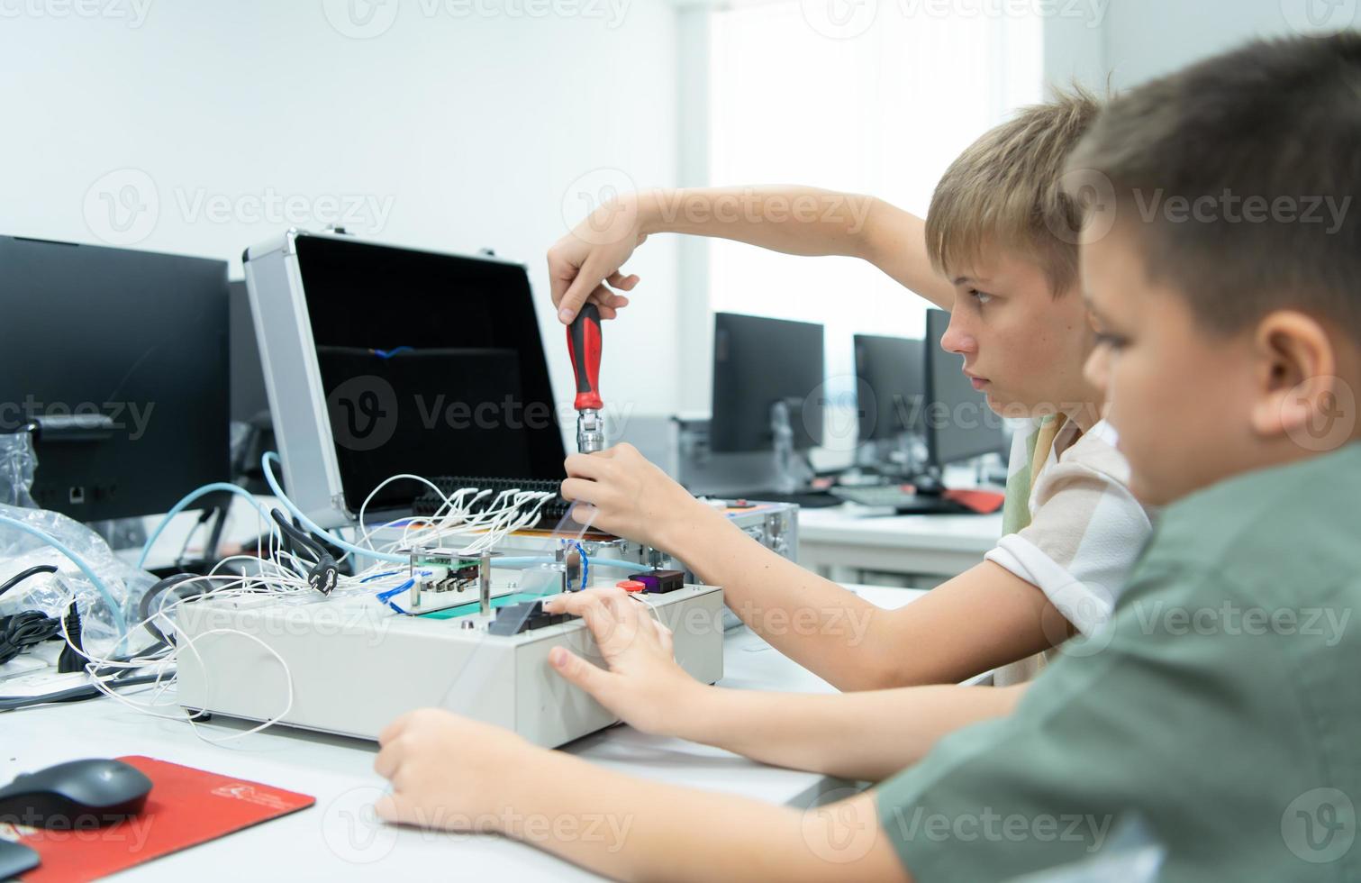 Youngsters utilizing the hand robot technology are having fun learning the electronic circuit board and hand robot controller of robot technology, which is one of the STEM courses. photo