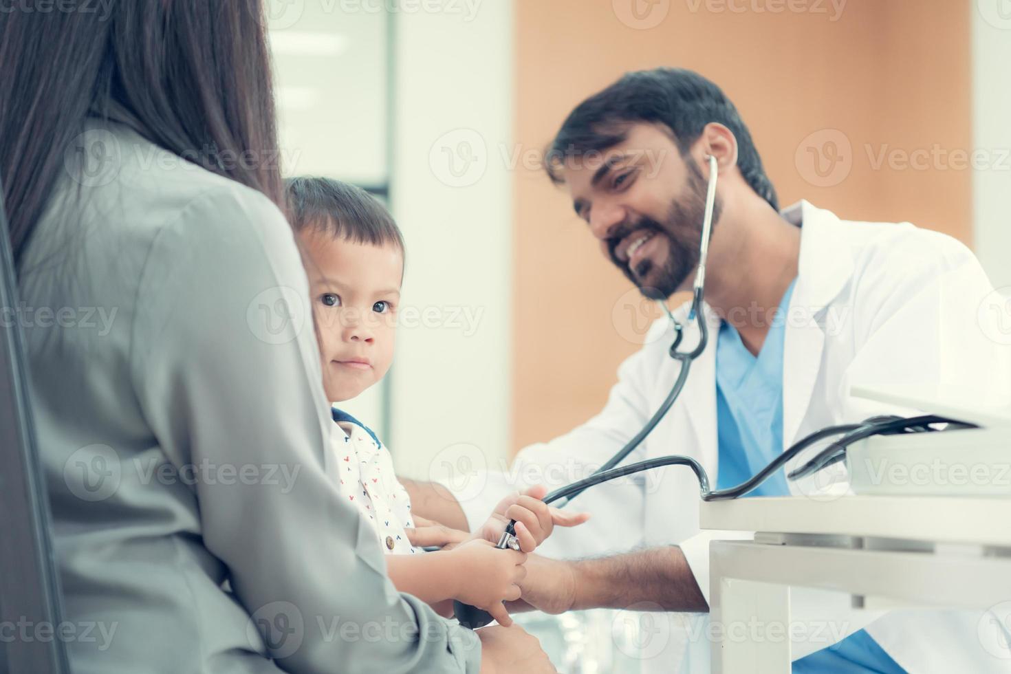 The pediatrician must try to play with the child. which parents brought to check the body to make it easier to examine the child photo