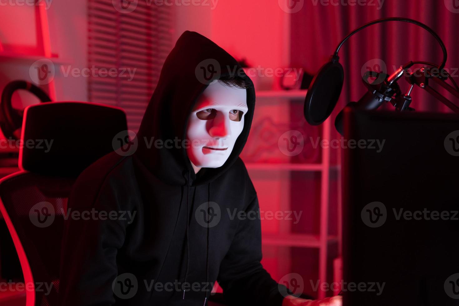 This is the face of a hacker who is knowledgeable with operating systems and other programs. He will exploit flaws and breach the computer system to cause damage. photo