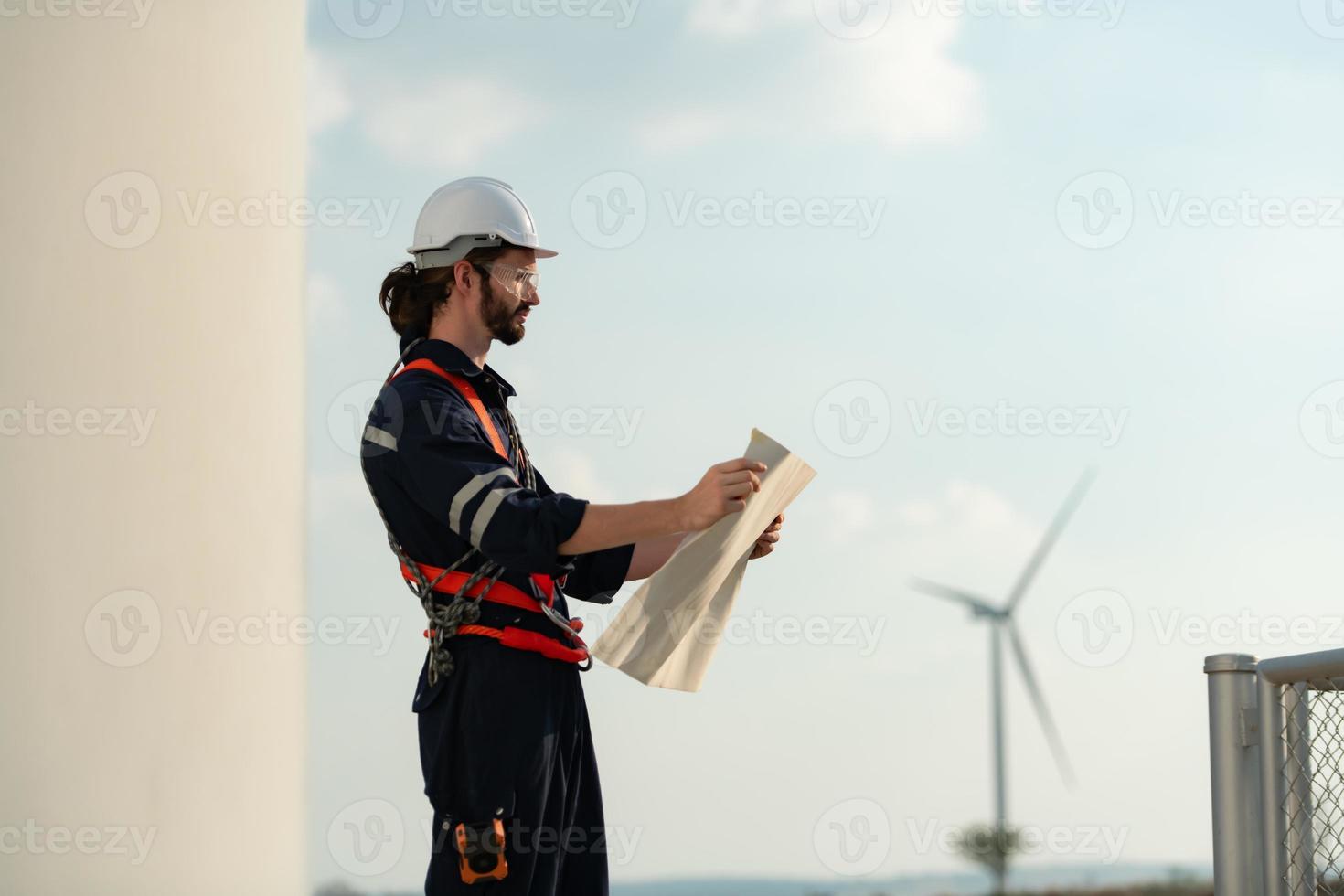 Engineer at Natural Energy Wind Turbine site with a mission to climb up to the wind turbine blades to inspect the operation of large wind turbines that converts wind energy into electrical energy photo