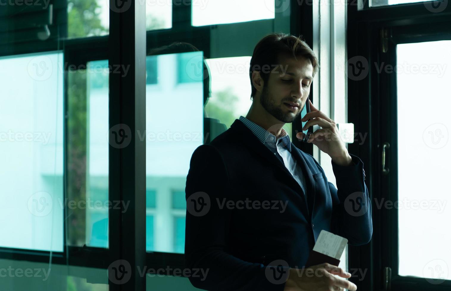Businessman with emotions while waiting for a long journey at the airport terminal photo