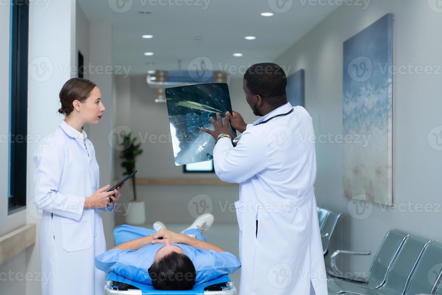 Medical teacher and interns see brain x-ray results of a patient who suffered a concussion after the accident. and inform the patient that the brain is normal photo