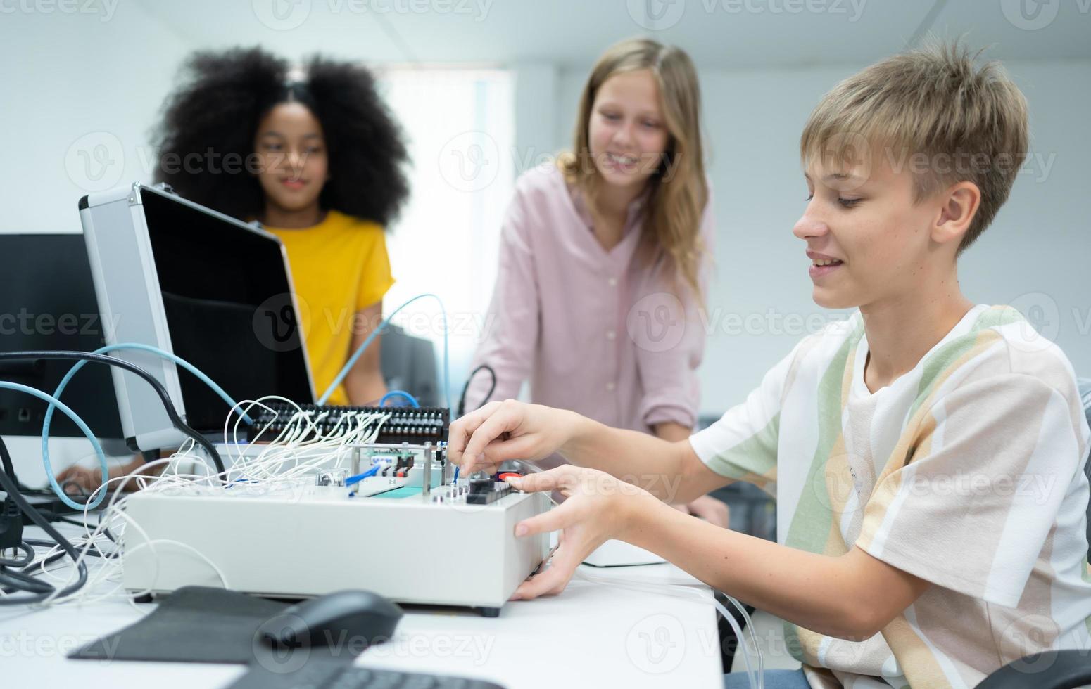 Youngsters utilizing the hand robot technology are having fun learning the electronic circuit board and hand robot controller of robot technology, which is one of the STEM courses. photo