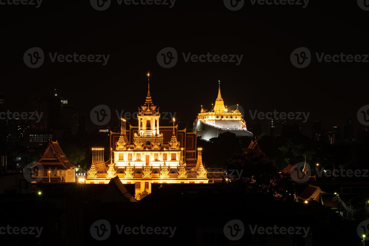 In the dark night, there was still a golden light in the central of Bangkok Thailand, The golden pagoda called the golden mountain temple, Tourist attractions that tourists visit to worship photo