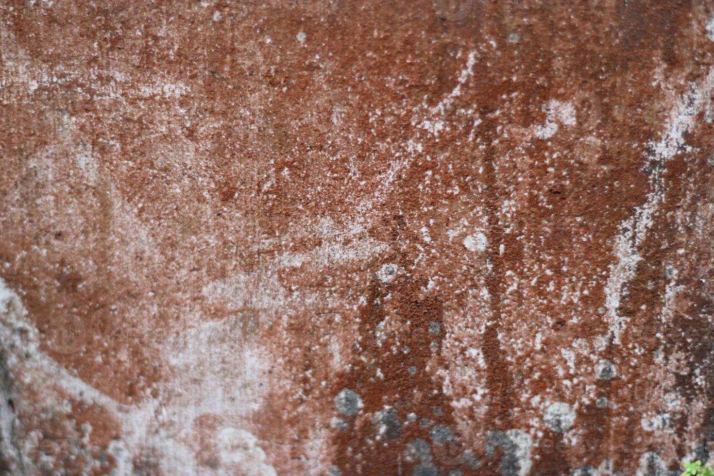 photo of red wall texture with cement on the wall