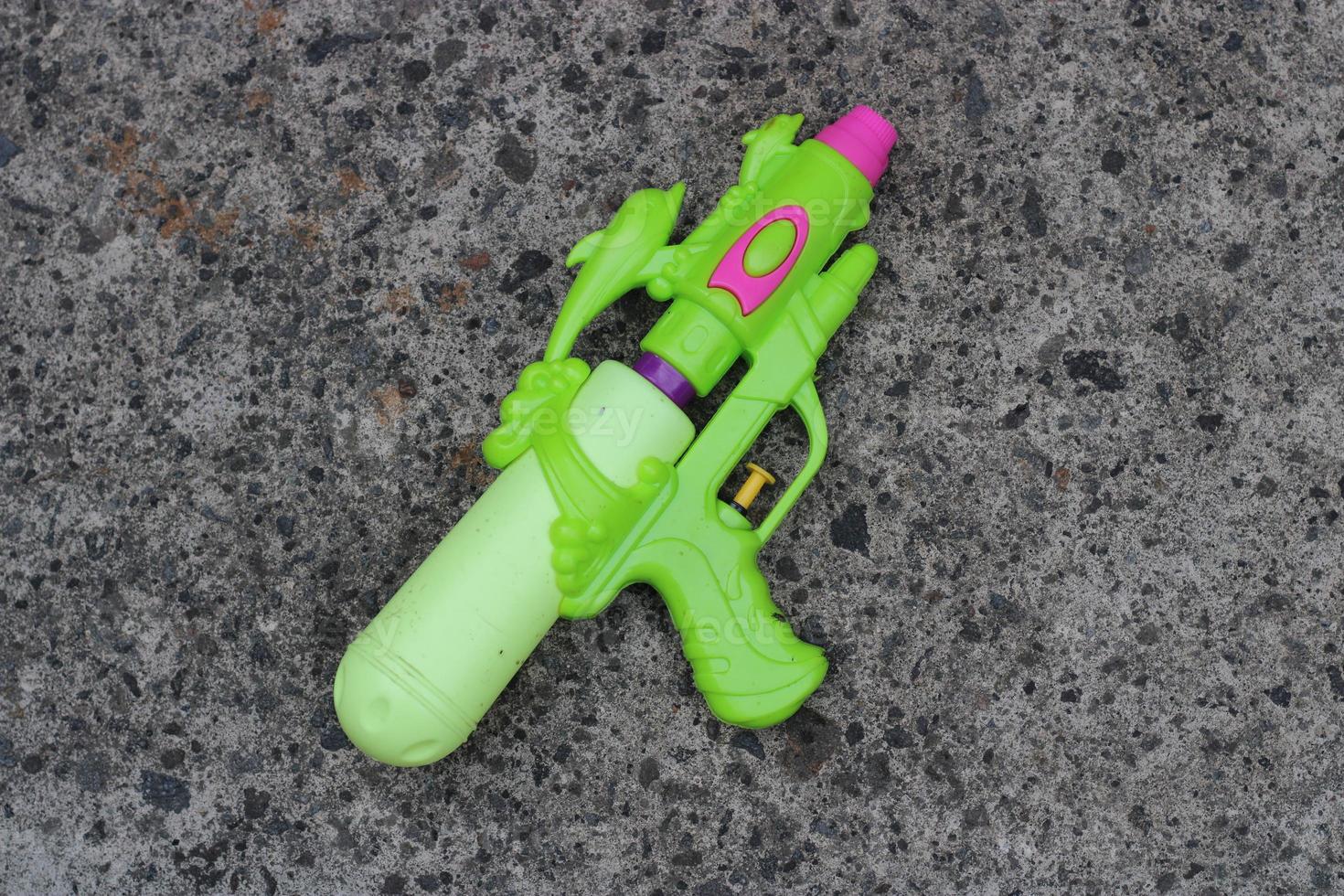 Photo of the green toy gun on the ground