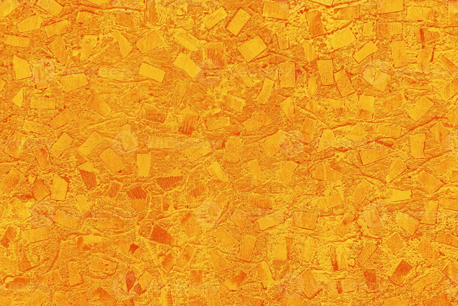 yellow-orange abstract texture of concrete painted wall with random mosaic pattern photo