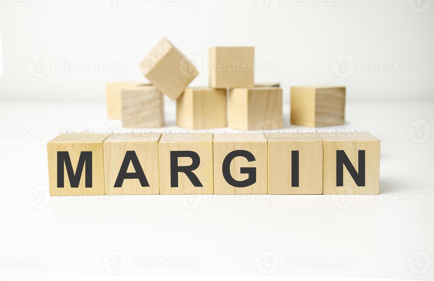 margin word made with wooden blocks and white background photo