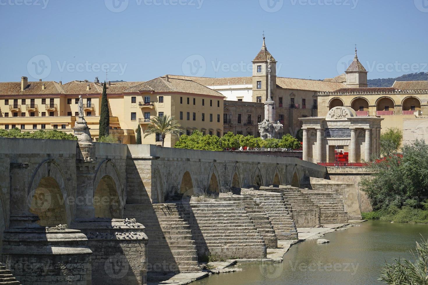 Roman Bridge on Guadalquivir River and Mezquita Mosque - Cathedral in Cordoba, Spain photo