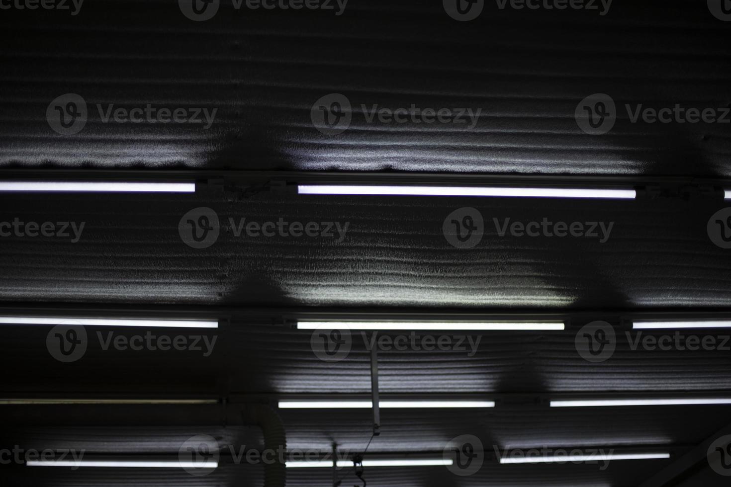 Fluorescent lamps. Ceiling in production room. Light in stock. photo