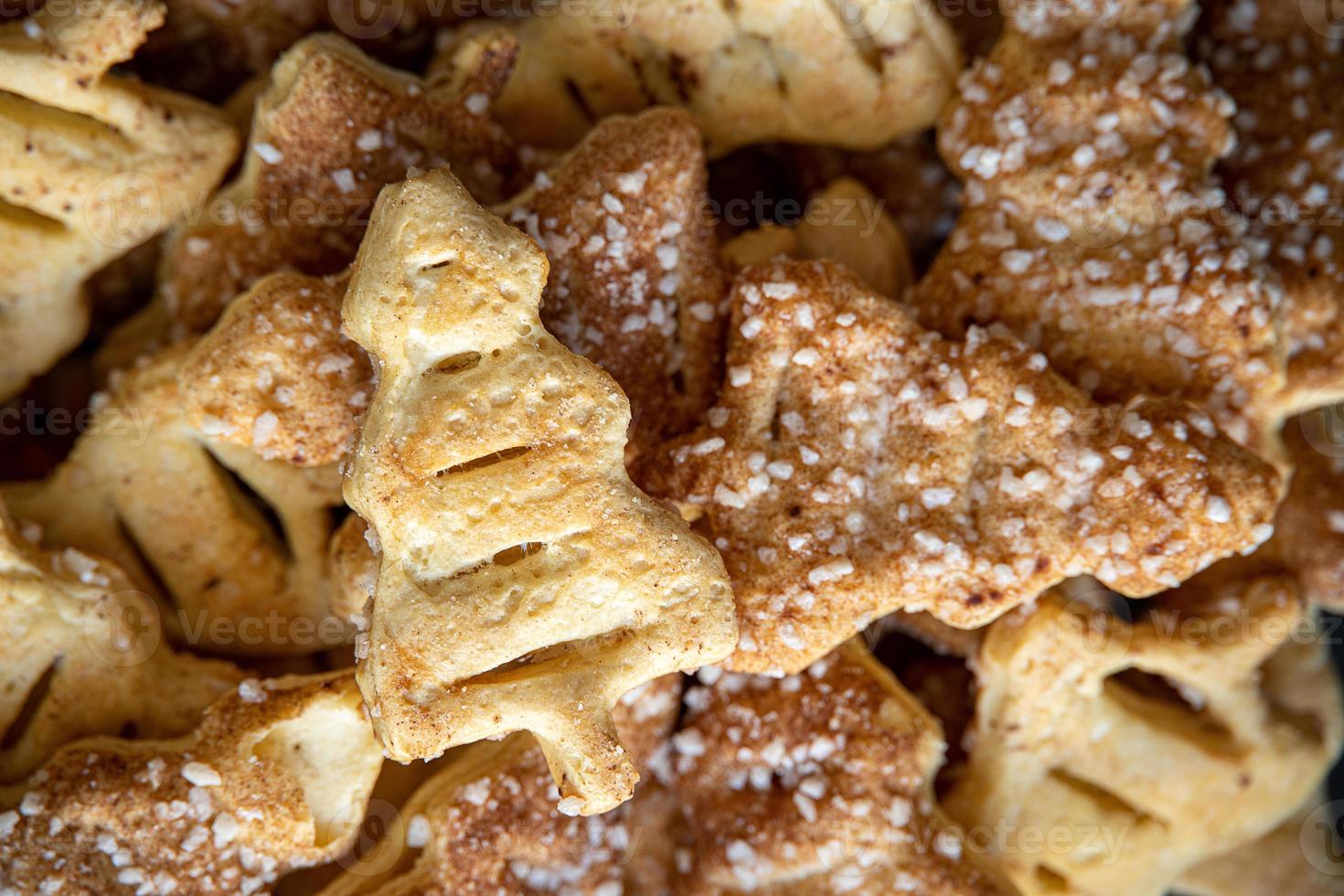 tasty background of cinnamon cakes from puff pastry in the shape of a Christmas tree in close-up photo