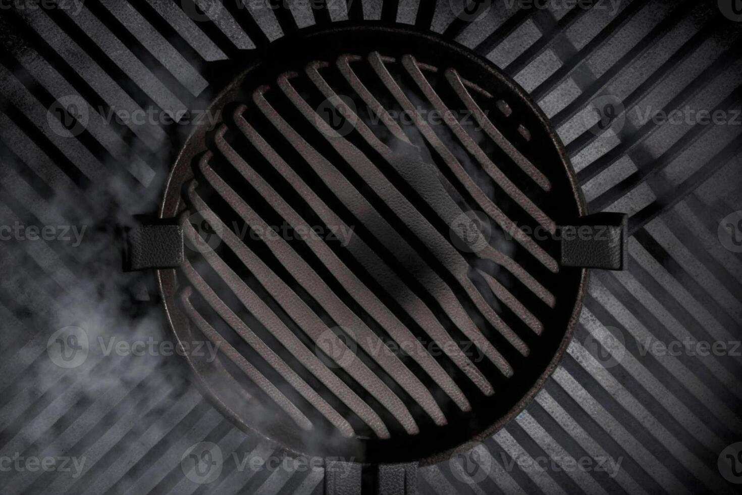 Top view of smoking smouldering charcoals under black cast iron grill grate ready for food cooking photo
