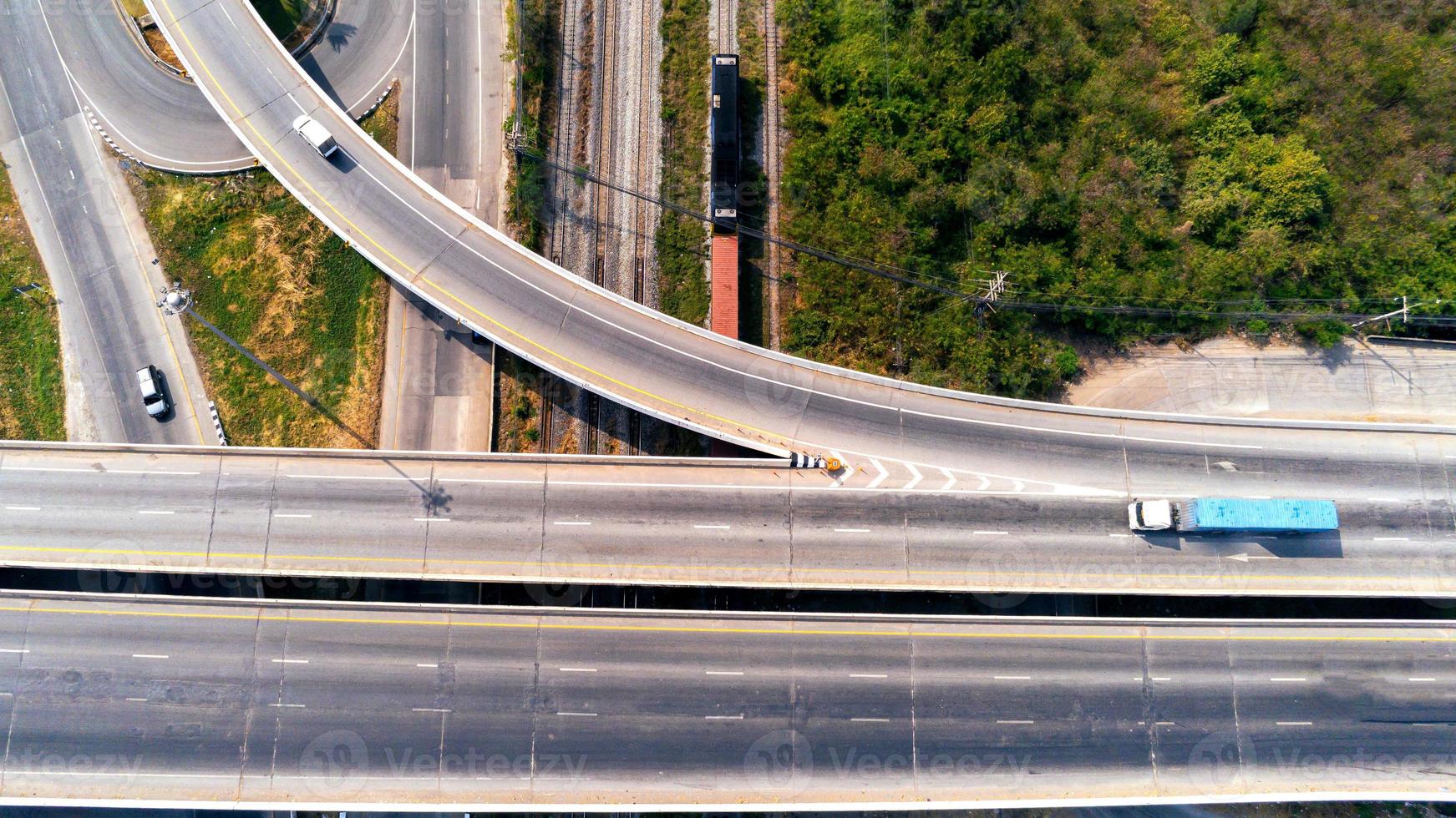 Aerial view of cargo Truck and train container on highway road with car, transportation concept.,import,export logistic industrial Transporting Land transport on the asphalt expressway photo