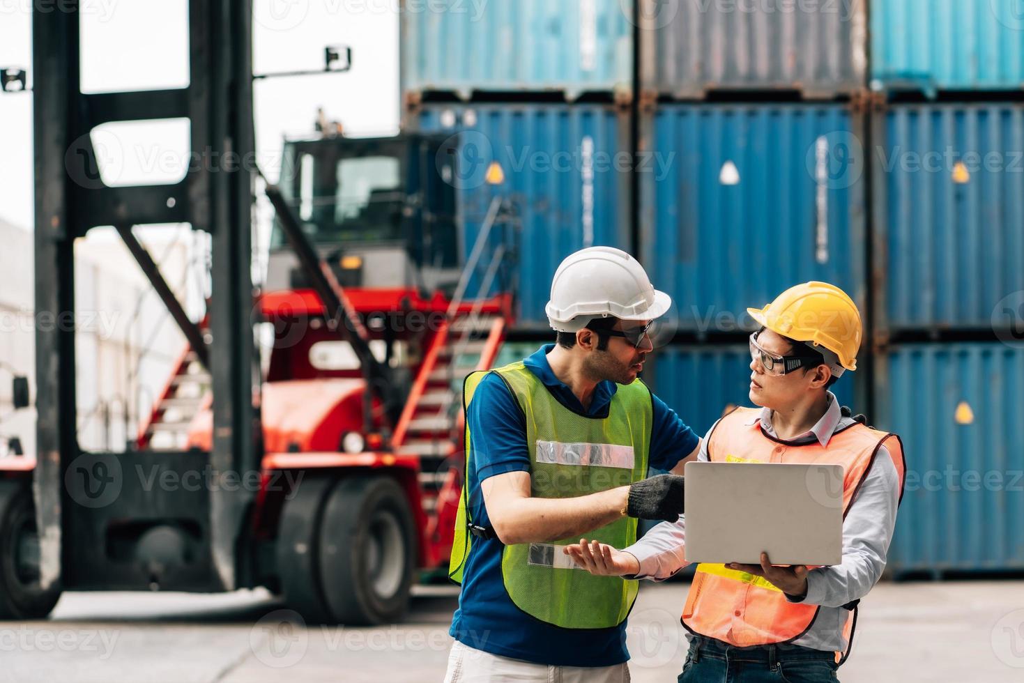 Team Engineer and worker wear safety uniform check control loading freight cargo container use computer laptop at commercial dock warehouse,transportation import,export logistic industrial service photo