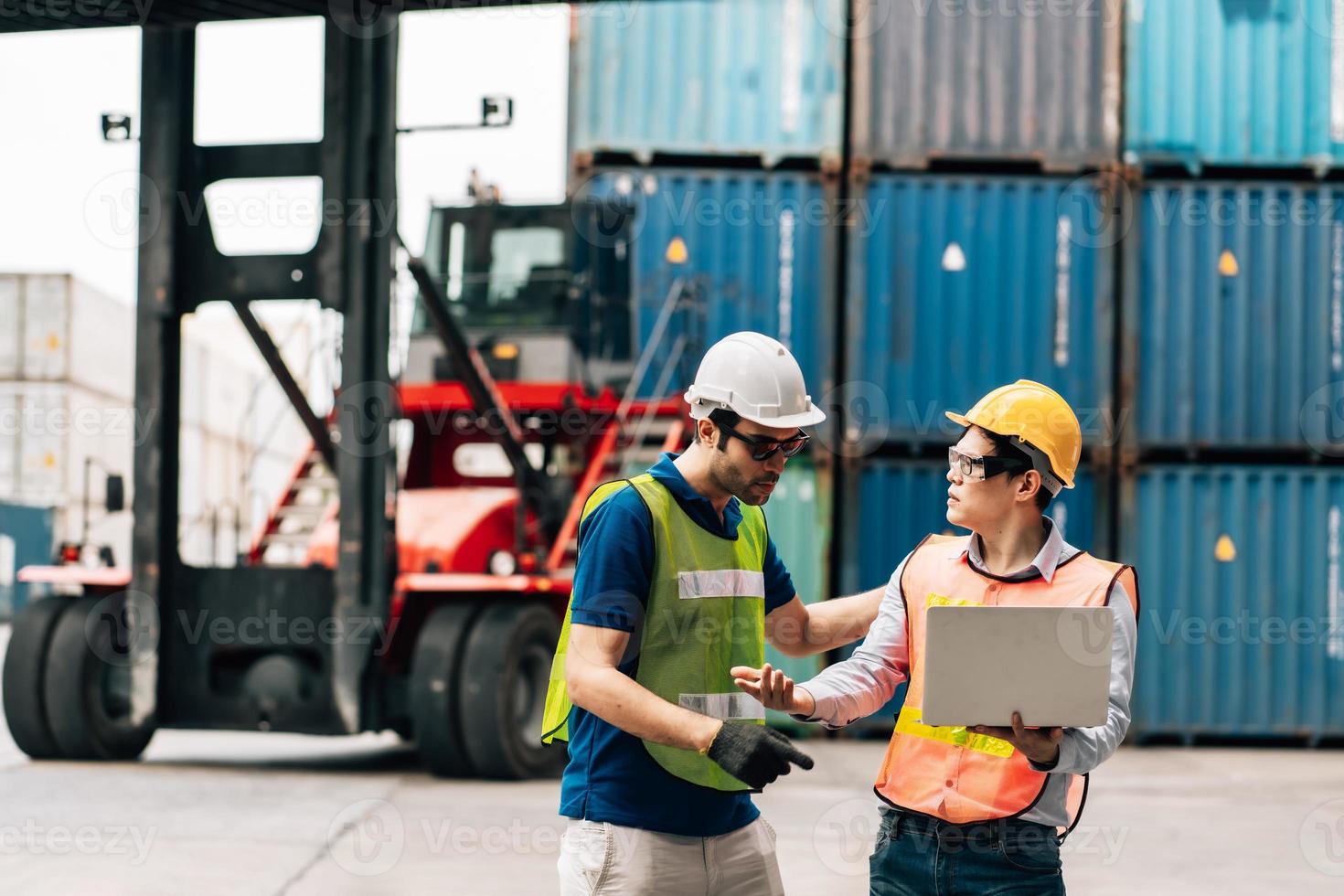 Team Engineer and worker wear safety uniform check control loading freight cargo container use computer laptop at commercial dock warehouse,transportation import,export logistic industrial service photo