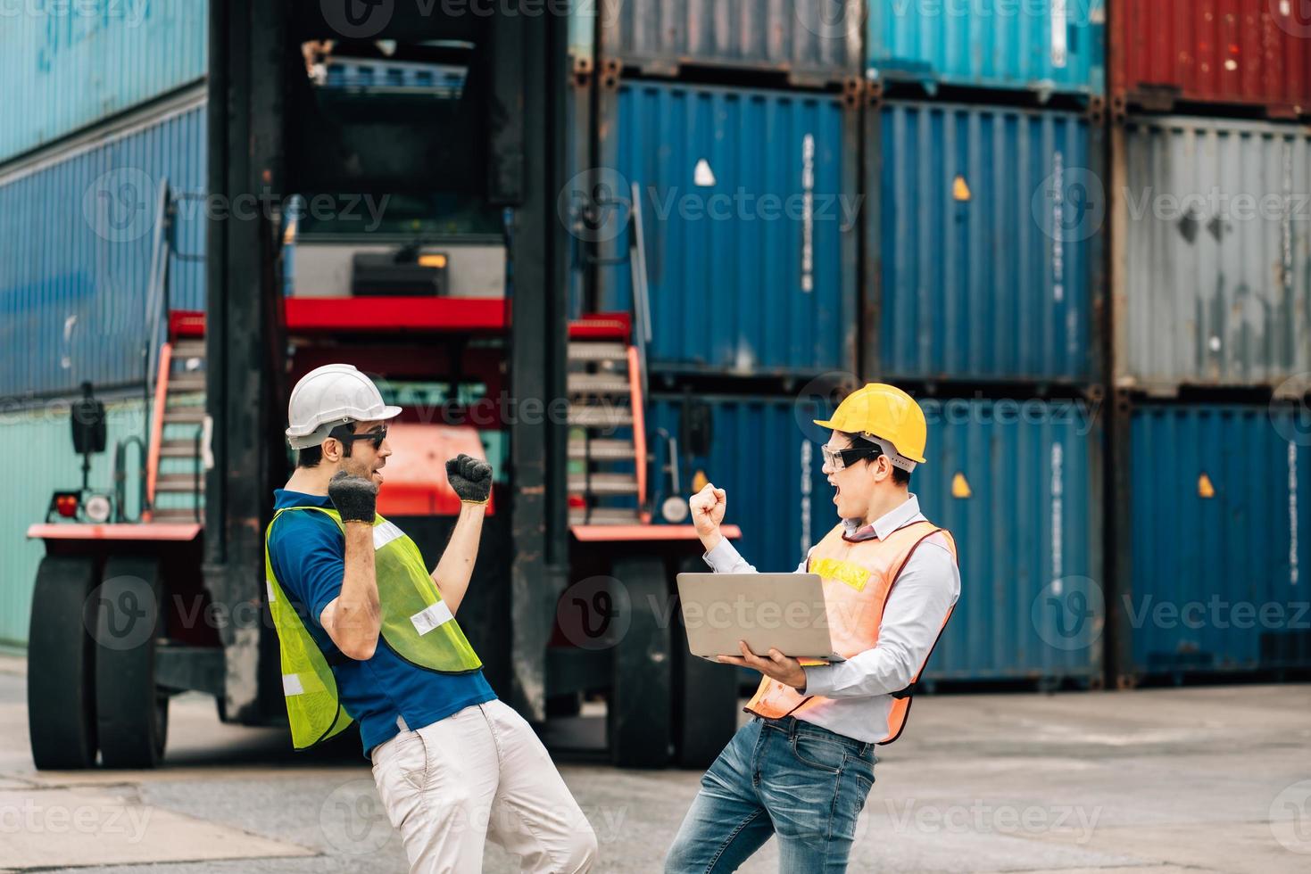 Team Engineer and worker wear safety uniform check control loading freight cargo container use computer laptop at commercial dock warehouse,transportation import,export logistic industrial service photo