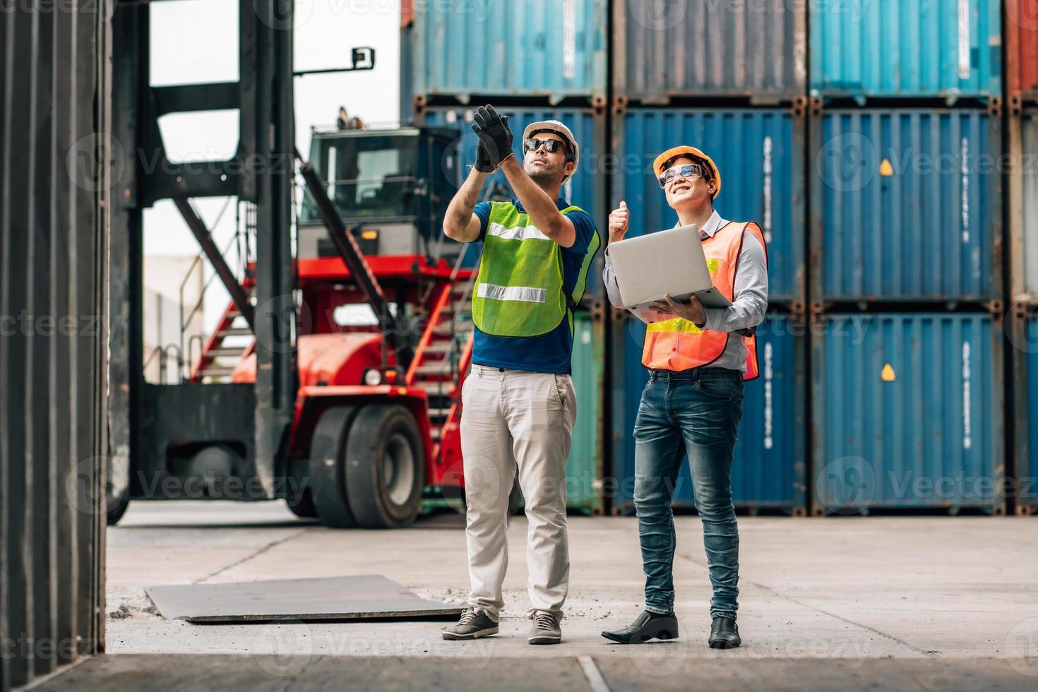 Team Engineer and worker wear safety uniform check control loading freight cargo container use computer laptop at commercial dock warehouse,transportation import,export logistic industrial service photo