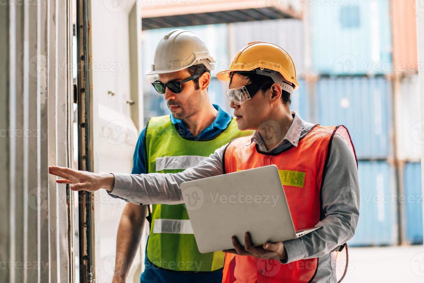 Team Engineer and worker wear safety uniform check control loading freight cargo container use computer laptop at commercial dock warehouse,transportation import,export logistic industrial service photo