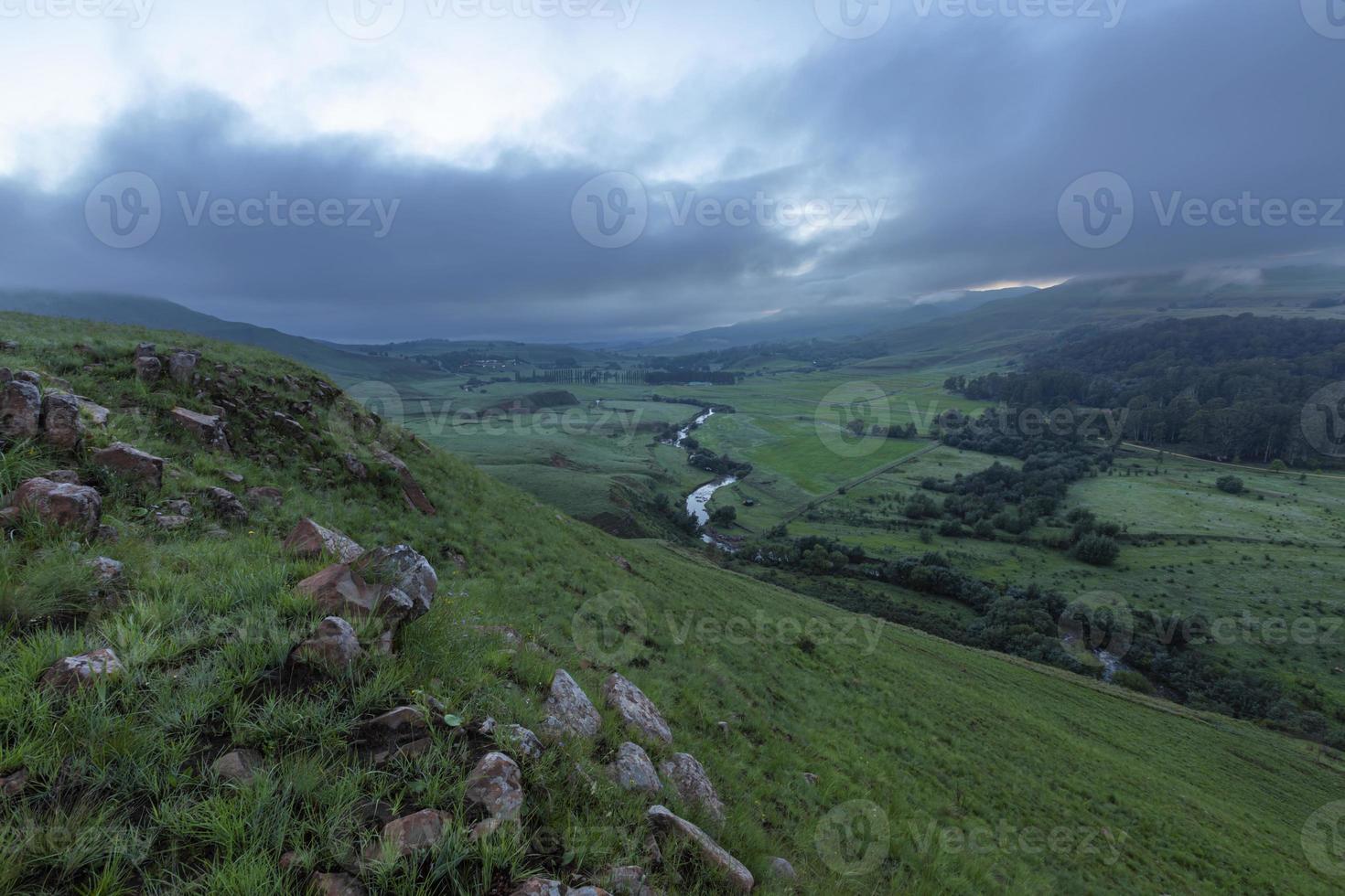 Boesmans river wind through green pastures below the mountain photo