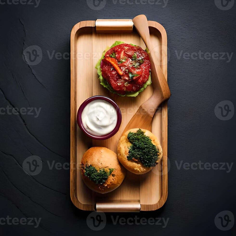 Bacon burger with tomato and cheese on wooden board top view. photo