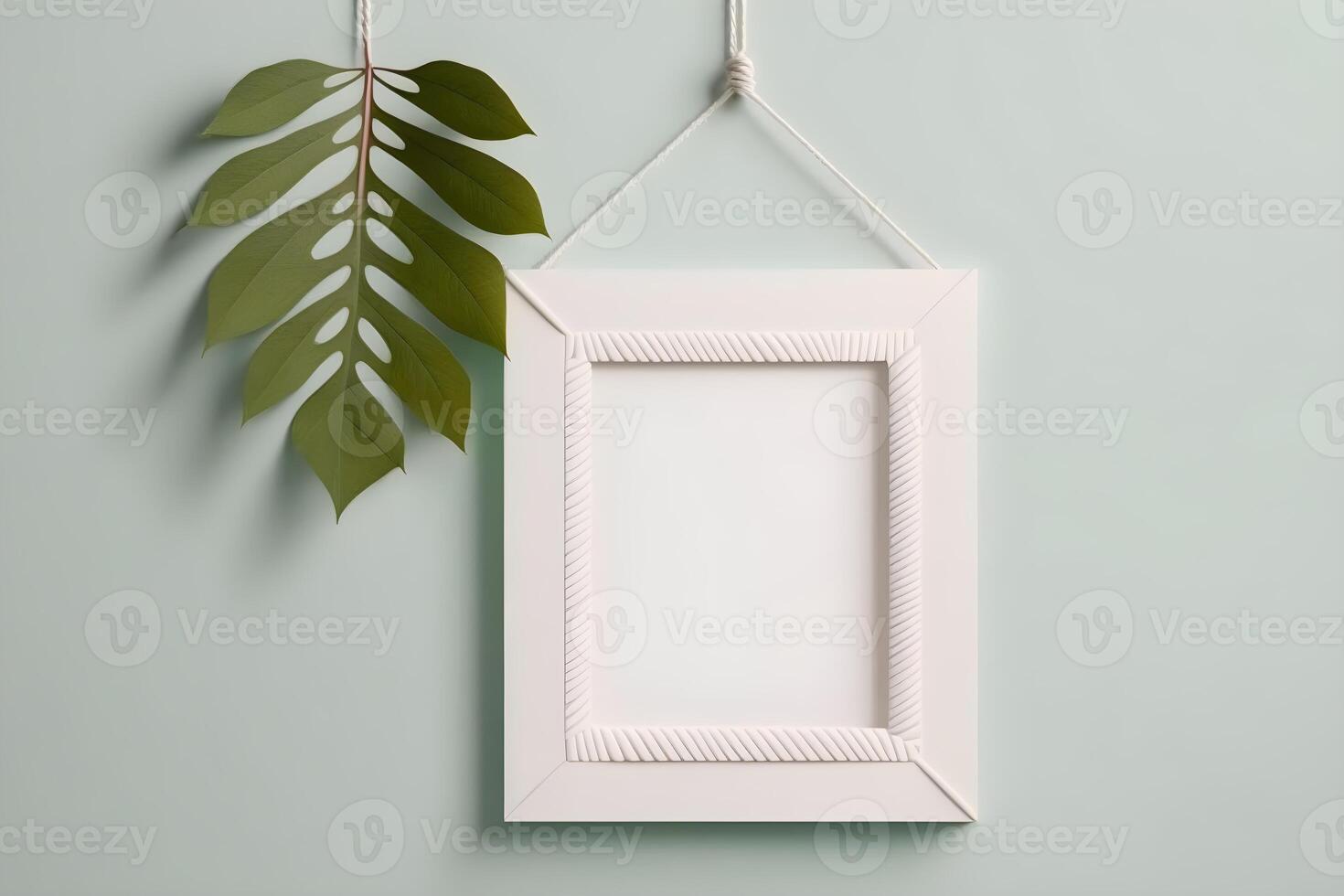 blank white frame on a pastel colored wall . photo
