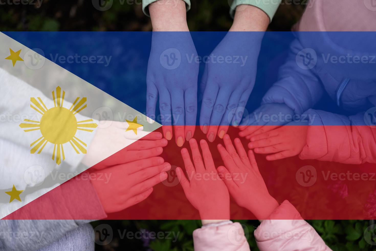 Hands of kids on background of Philippines flag. Filipino patriotism and unity concept. photo