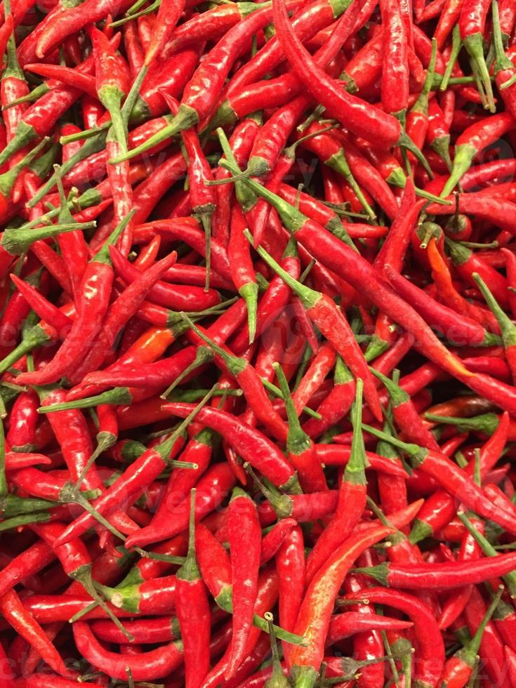 Red hot chilli peppers pattern texture background. Close up. Landscape. A backdrop ofRed hot chilli peppers. Street vegetable market. Group of Red hot chilli peppers photo