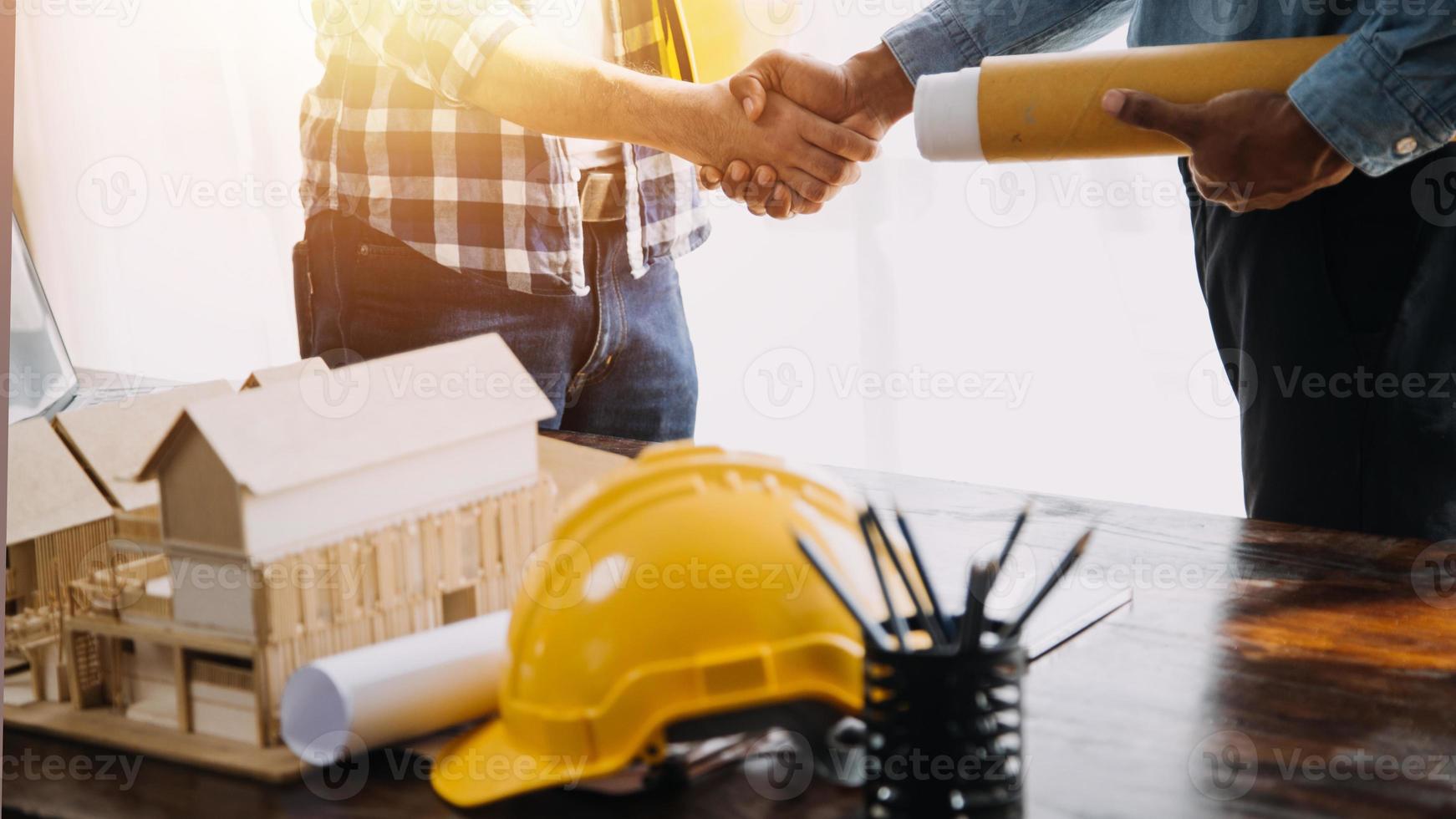 Two business man construction site engineer. Engineering objects on workplace with partners interacting on background photo