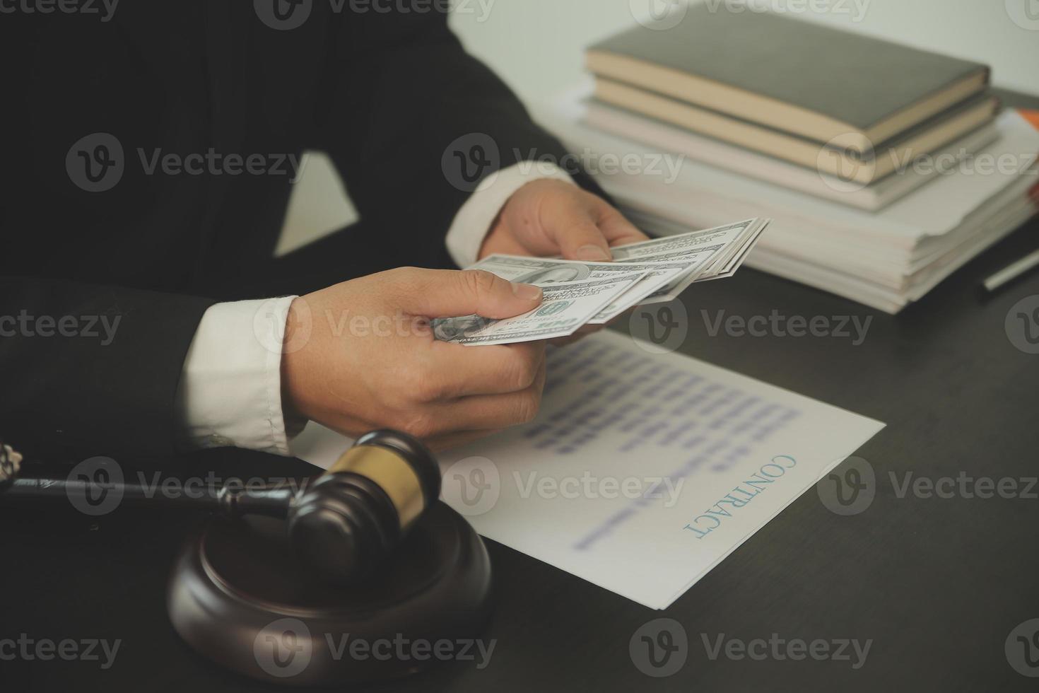 Justice and Law concept. Legal counsel presents to the client a signed contract with gavel and legal law or legal having team meeting at law firm in background photo