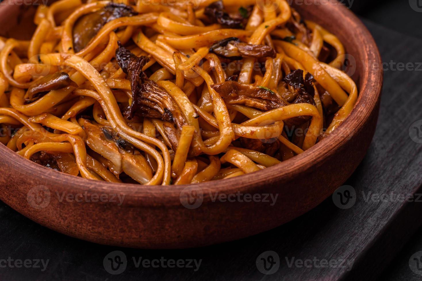 Delicious noodles or udon with mushrooms, salt, spices and herbs photo