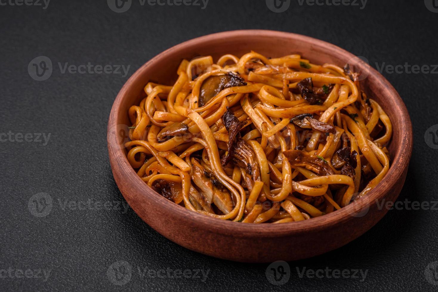Delicious noodles or udon with mushrooms, salt, spices and herbs photo