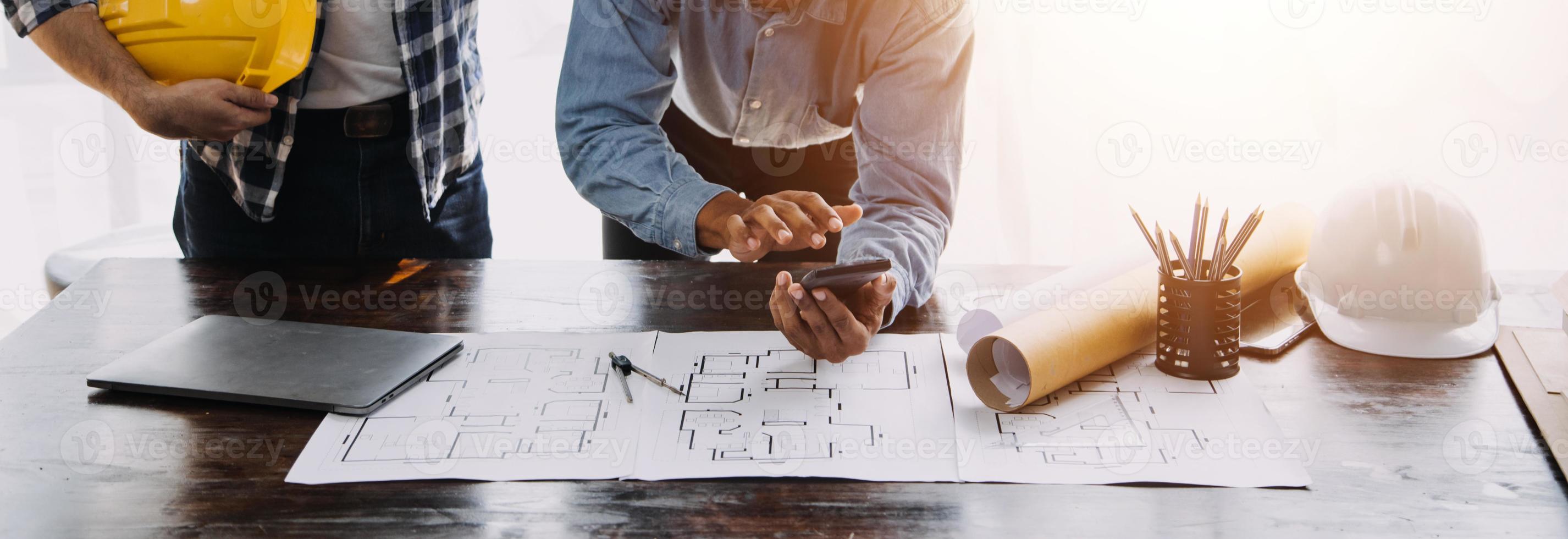 Two business man construction site engineer. Engineering objects on workplace with partners interacting on background photo