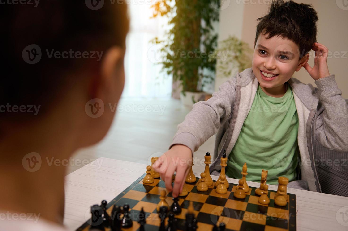 Concentrated serious boy developing chess gambit, strategy ,playing board  game to winner clever concentration and thinking child while playing chess.  Learning, tactics and analysis concept. 7292819 Stock Photo at Vecteezy