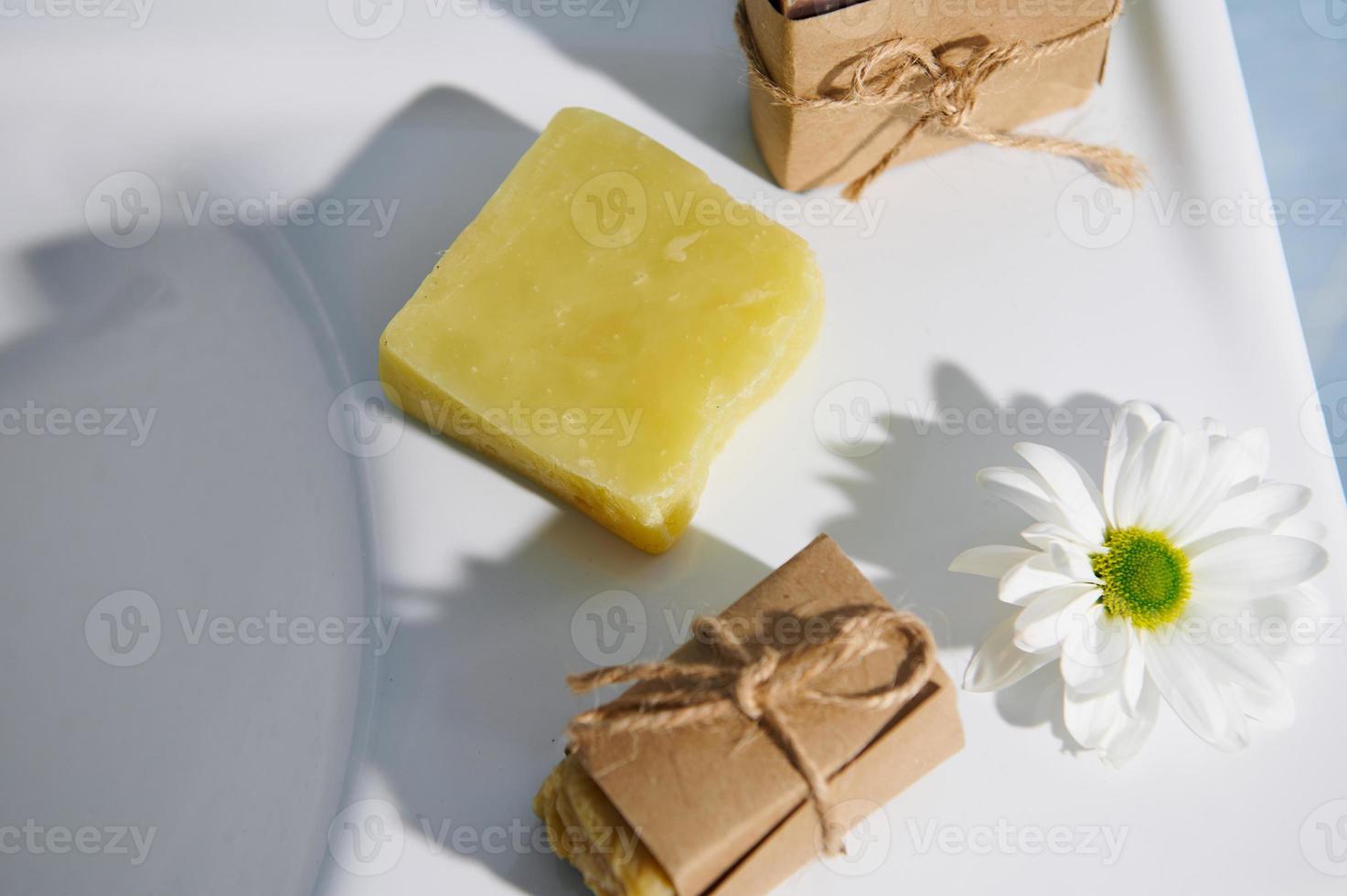 Top view organic natural cosmetic soap bars on a white ceramic washbasin. natural cosmetics, hygiene and beauty concept photo
