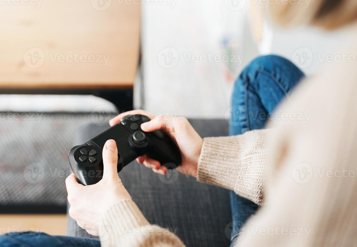 Girl playing on games console photo