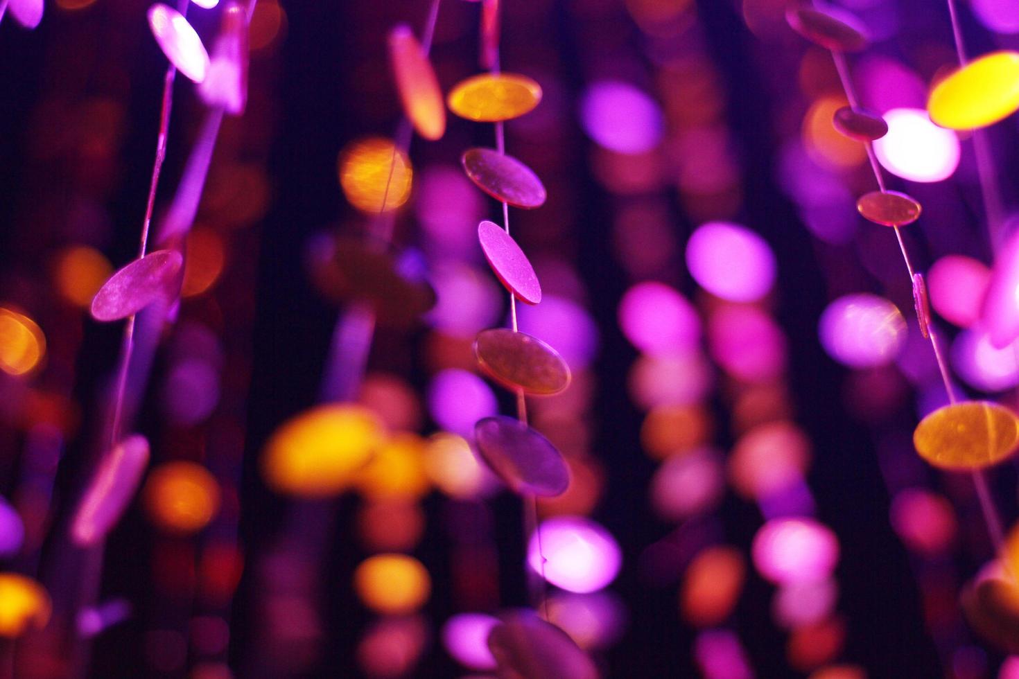 Glamour Ultra Violet sparkling and purple glitter bokeh of metallic circle. Multicolored Christmas and New Year glowing light abstract for Christmas and holiday concept. photo
