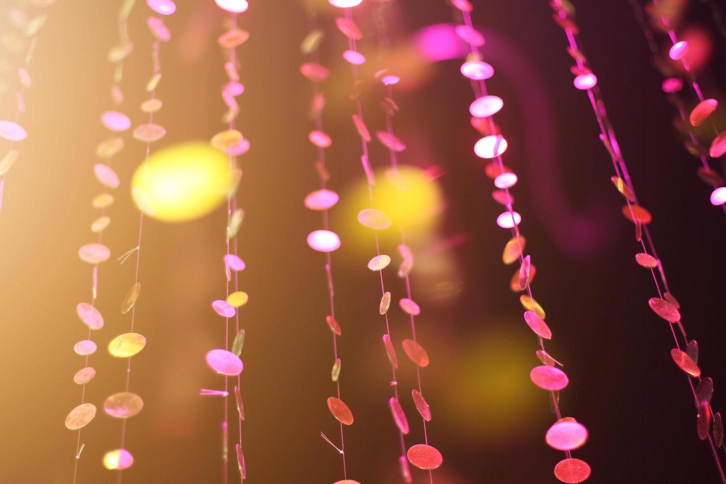 Glamour sparkling and purple glitter bokeh of golden metallic circle. Multicolored Christmas and New Year glowing light abstract for Christmas and holiday concept. photo