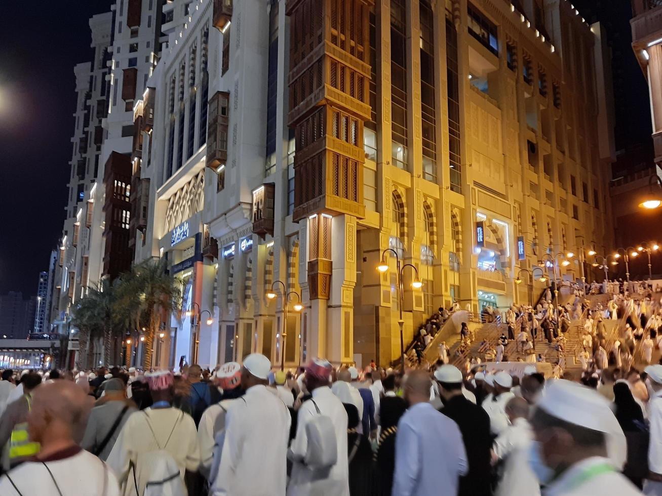 Mecca, Saudi Arabia, April 2023 - A beautiful view of pilgrims, tall buildings and lights at night on the outer road in Masjid al-Haram, Mecca. photo
