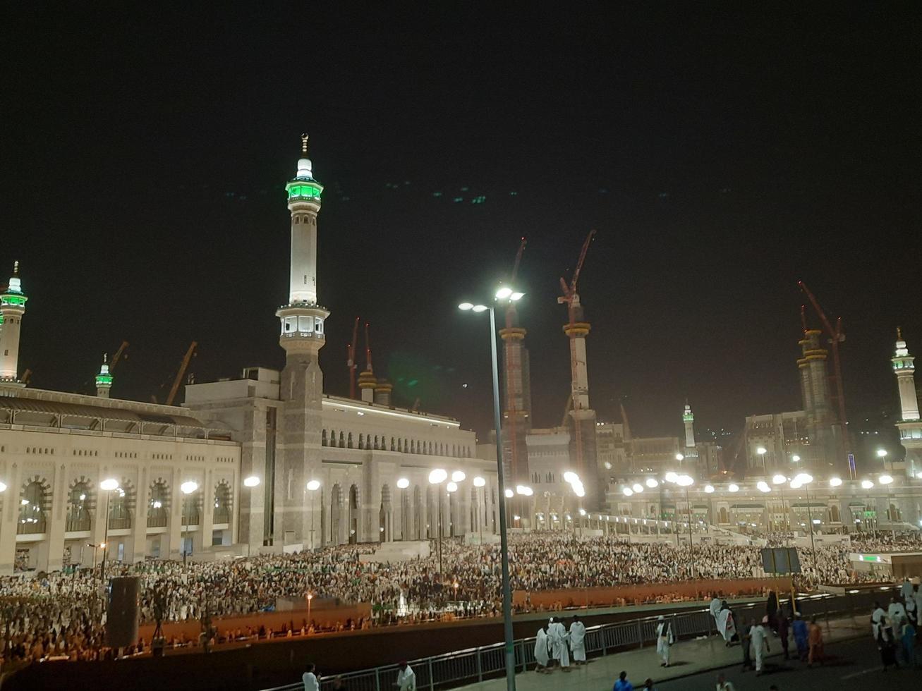 Mecca, Saudi Arabia, April 2023 - A beautiful view of pilgrims, tall buildings and lights at night on the outer road in Masjid al-Haram, Mecca. photo