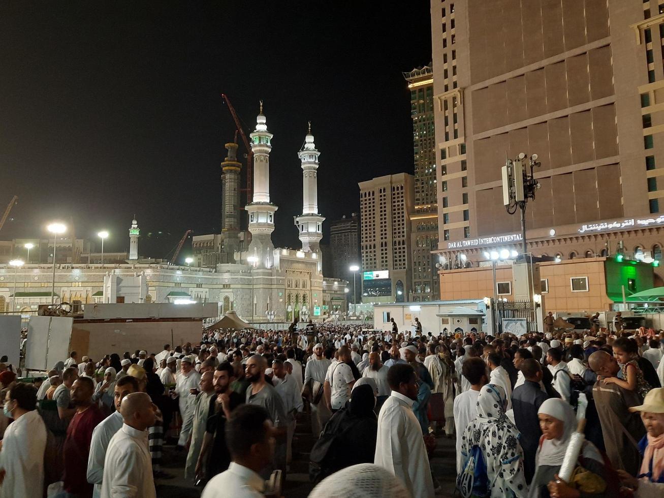 Mecca, Saudi Arabia, April 2023 - A beautiful view of pilgrims, tall buildings and lights at night on the outer road in Masjid al-Haram, Mecca. photo